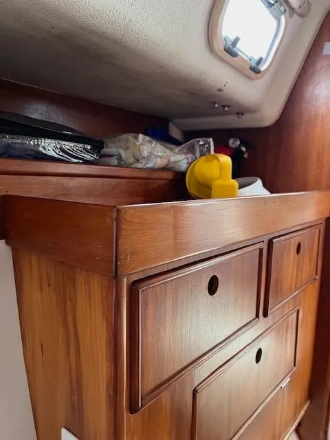 Slide: The Image of Wooden storage drawers inside a 1999 Contour 34 SC sailboat cabin. - 23