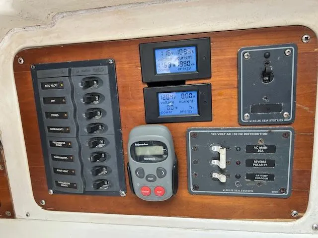 Slide: The Image of 1999 Contour 34 SC control panel with switches, meters, and navigation equipment. - 27