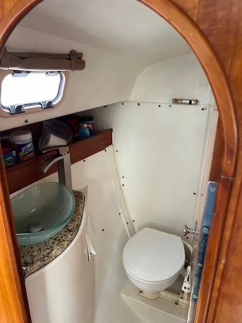 Slide: The Image of 1999 Contour 34 SC boat bathroom with modern sink and toilet. - 34