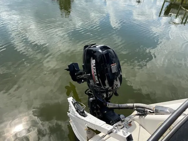 Slide: The Image of 1999 Contour 34 SC boat with Suzuki outboard motor on calm water. - 41