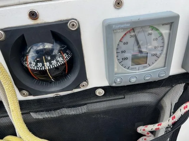 Slide: The Image of Boat navigation instruments on a 1999 Contour 34 SC, including a compass and wind gauge. - 43