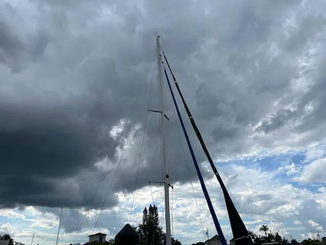 Slide: The Image of Sailboat mast of 1999 Contour 34 SC under cloudy sky. - 6