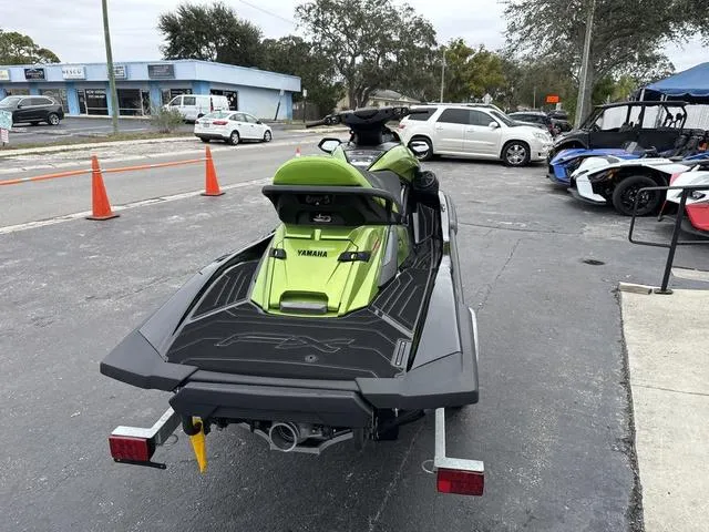 Slide: The Image of 2024 Yamaha Marine Waverunner FX Cruiser SVHO with Audio, green, on trailer in parking lot. - 10