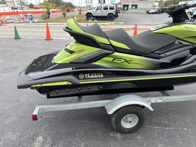 Slide: The Image of 2024 Yamaha Marine Waverunner FX Cruiser SVHO on trailer, green and black design. - 11