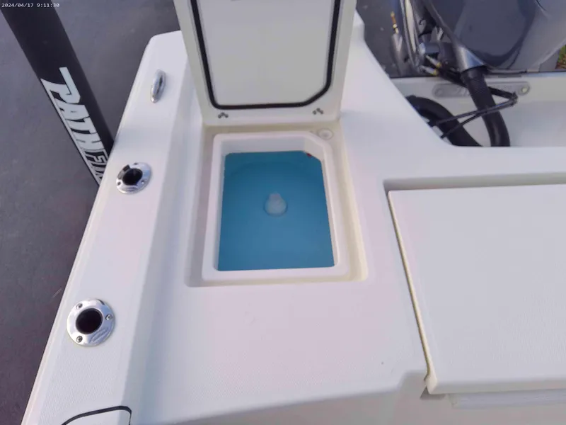 Slide: The Image of 2025 Pathfinder 2200 TRS boat with open storage compartment and rod holders. - 10