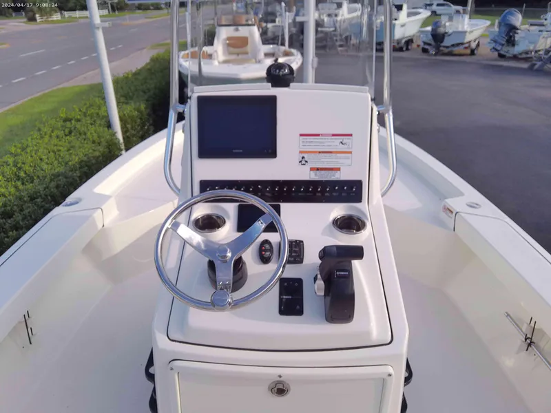 Slide: The Image of 2025 Pathfinder 2200 TRS boat console with steering wheel and navigation system. - 3