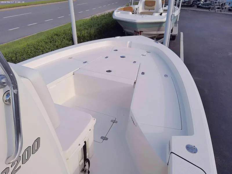 Slide: The Image of 2025 Pathfinder 2200 TRS boat, white deck, spacious seating, and storage compartments. - 4