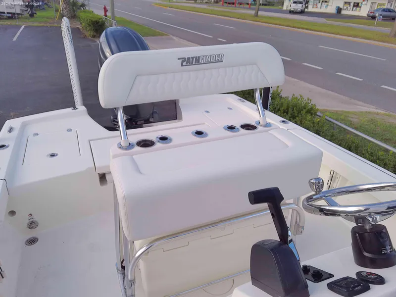 Slide: The Image of 2025 Pathfinder 2200 TRS boat interior with steering wheel and seating. - 6