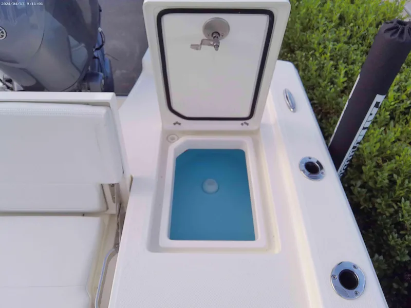 Slide: The Image of 2025 Pathfinder 2200 TRS boat with open storage compartment and blue interior. - 9