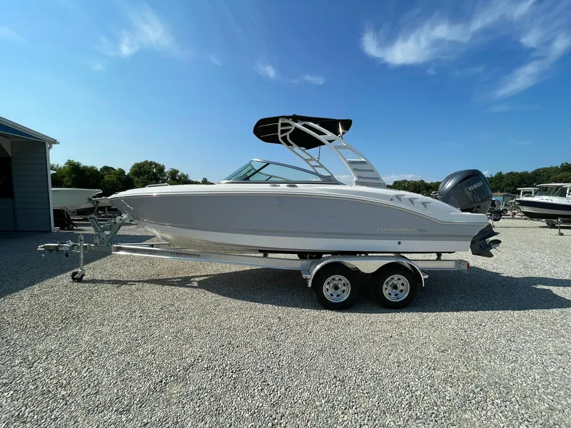 The Image of 2024 Chaparral 21 SSi OB boat on a trailer under a clear blue sky. - 0