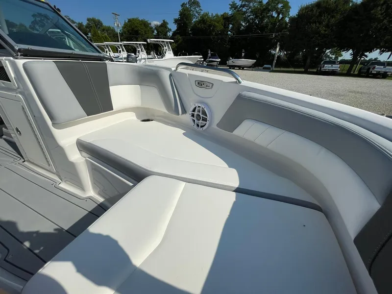 Slide: The Image of 2024 Chaparral 21 SSi OB boat interior with white and gray seating. - 11