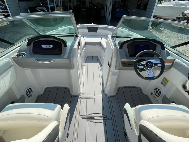 Slide: The Image of 2024 Chaparral 21 SSi OB boat interior with dual consoles and steering wheel. - 14