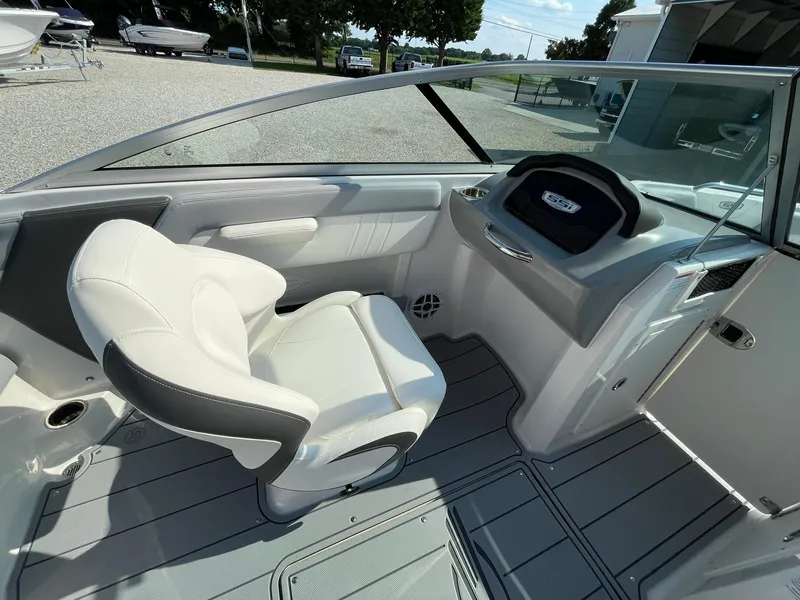 Slide: The Image of 2024 Chaparral 21 SSi OB boat interior with captain's chair and dashboard. - 16