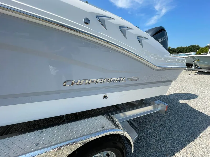 Slide: The Image of 2024 Chaparral 21 SSi OB boat side view on trailer. - 2