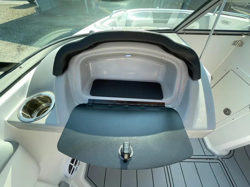 Slide: The Image of 2024 Chaparral 21 SSi OB boat interior storage compartment with open lid. - 20