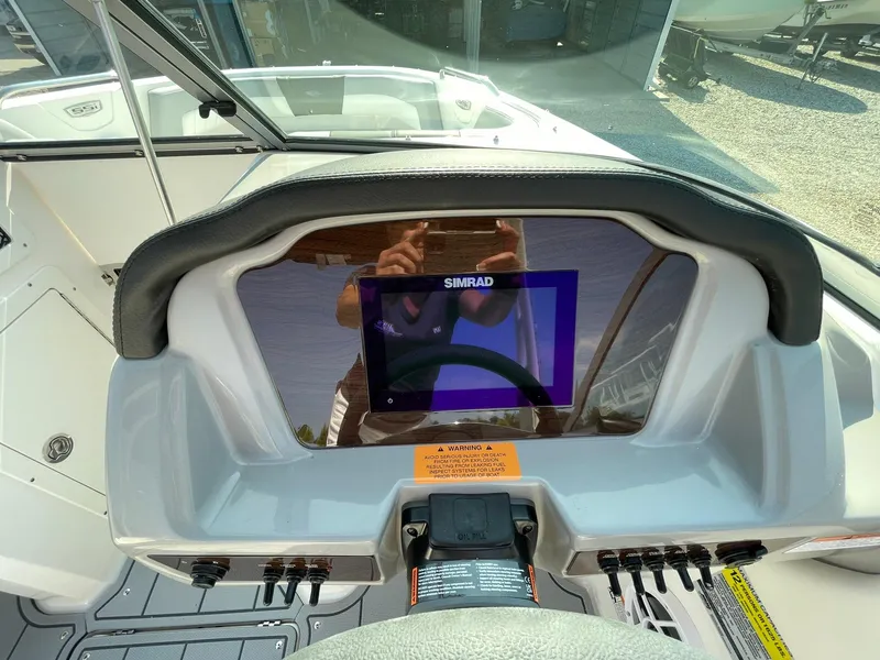 Slide: The Image of 2024 Chaparral 21 SSi OB boat dashboard with Simrad display. - 23