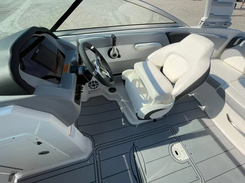 Slide: The Image of 2024 Chaparral 21 SSi OB boat interior with steering wheel and captain's seat. - 26