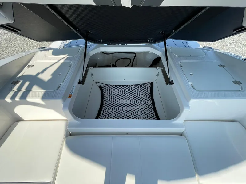 Slide: The Image of 2024 Chaparral 21 SSi OB boat storage compartment with open hatch. - 41