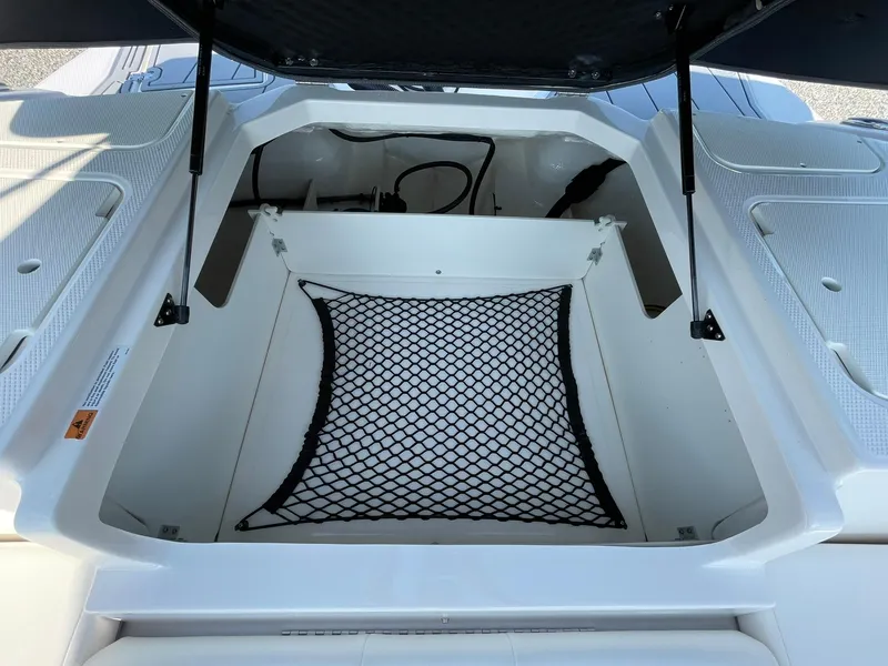 Slide: The Image of 2024 Chaparral 21 SSi OB boat storage compartment with netting. - 42