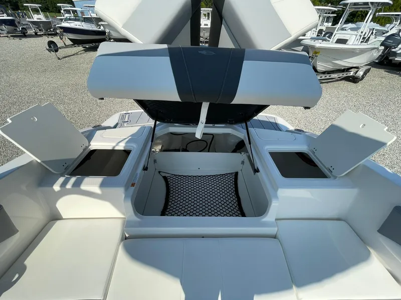 Slide: The Image of 2024 Chaparral 21 SSi OB boat with open storage compartments and seating area. - 44
