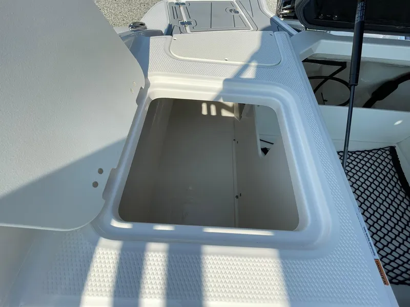 Slide: The Image of Open storage compartment on the 2024 Chaparral 21 SSi OB boat. - 46