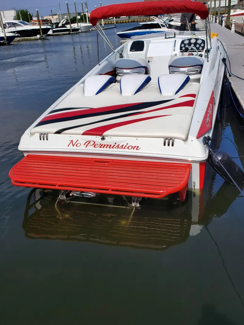 Slide: The Image of 2007 Baja Outlaw 35 speedboat docked, featuring red and white design with "No Permission" text. - 2