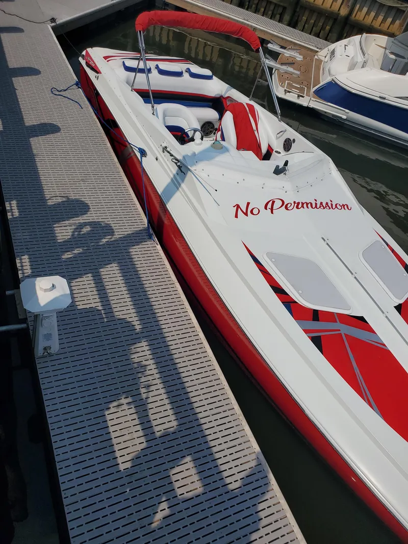 Slide: The Image of 2007 Baja Outlaw 35 speedboat docked, featuring red and white design with "No Permission" text. - 3