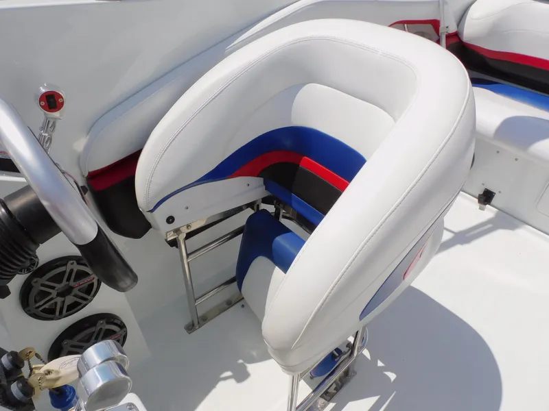 Slide: The Image of 2007 Baja Outlaw 35 boat interior with white, blue, and red seating. - 40