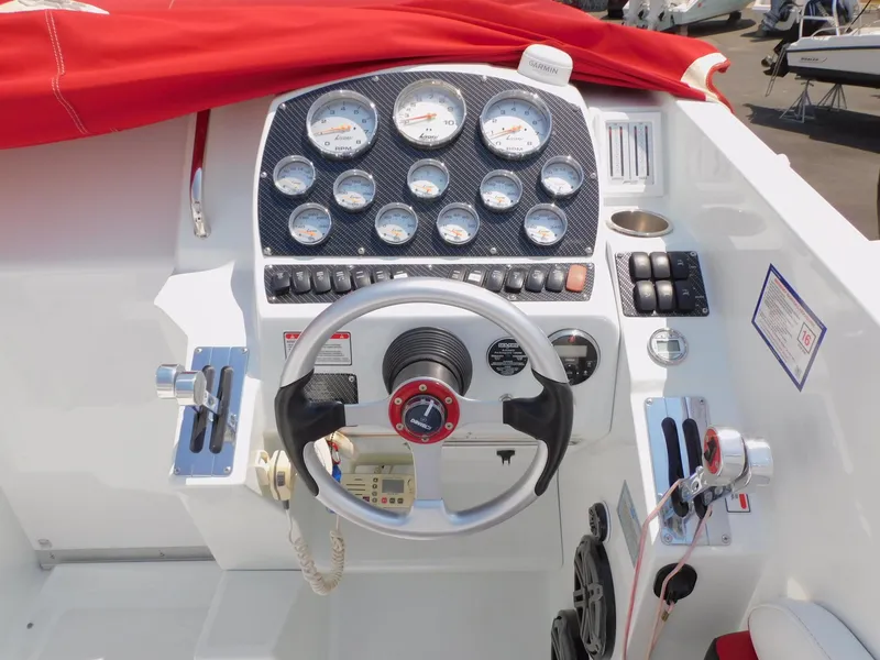 Slide: The Image of 2007 Baja Outlaw 35 boat dashboard with gauges, steering wheel, and controls. - 41