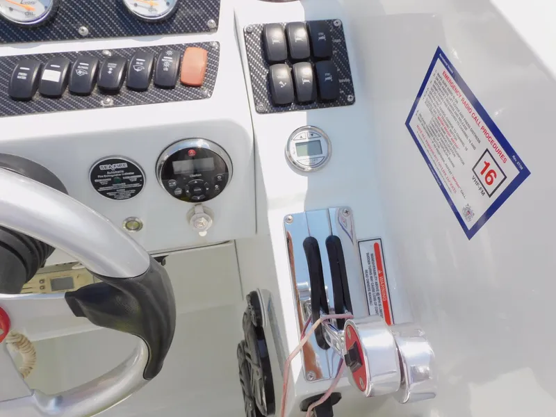 Slide: The Image of 2007 Baja Outlaw 35 boat dashboard with controls and emergency radio call procedures. - 43