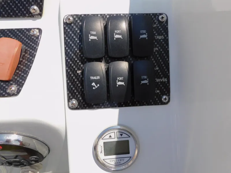 Slide: The Image of Control panel of a 2007 Baja Outlaw 35 boat with trim and trailer switches. - 46