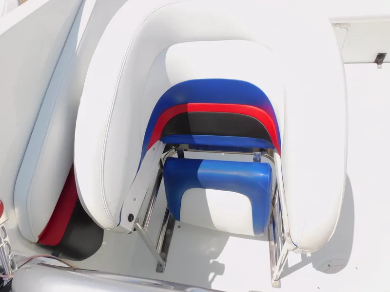 Slide: The Image of 2007 Baja Outlaw 35 boat seat with white, blue, red, and black upholstery. - 50