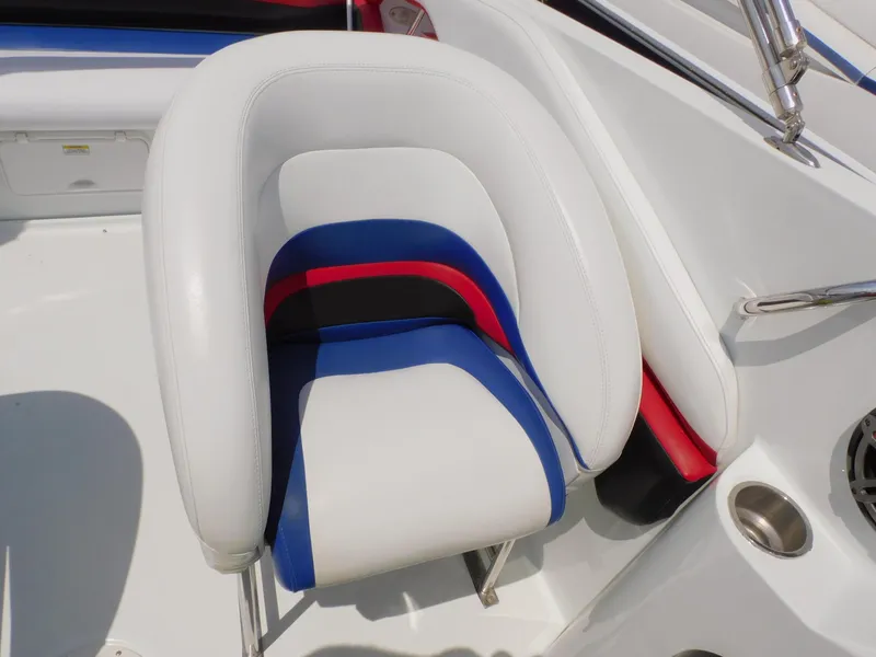Slide: The Image of 2007 Baja Outlaw 35 boat seat with white, blue, red, and black upholstery. - 51