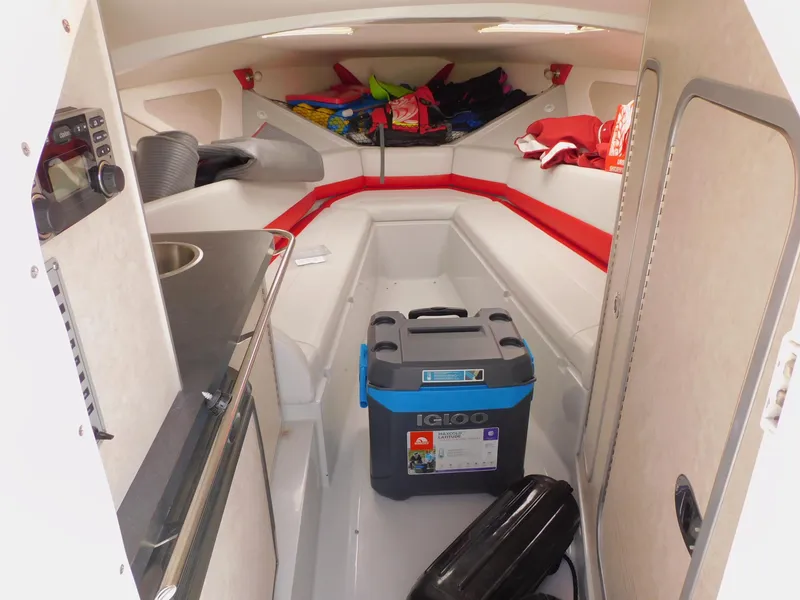 Slide: The Image of Interior of a 2007 Baja Outlaw 35 boat with seating, storage, and a small sink. - 54