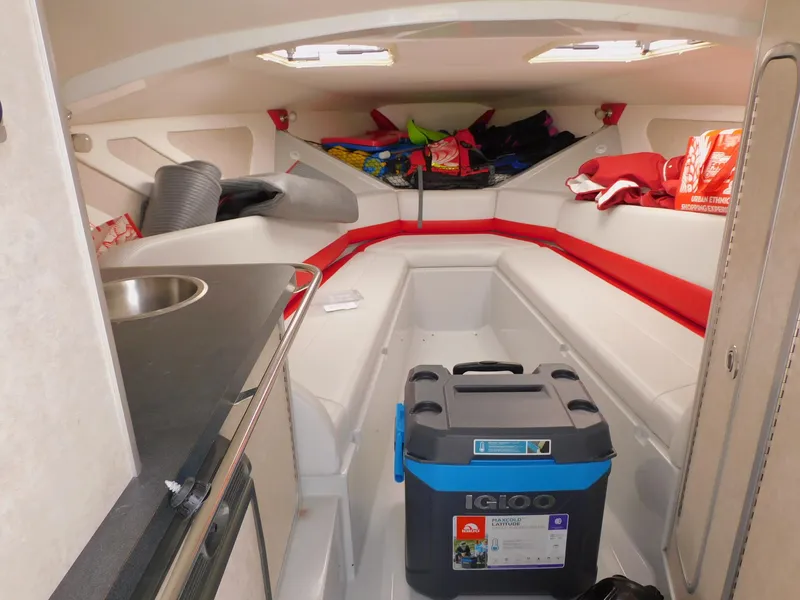 Slide: The Image of Interior of a 2007 Baja Outlaw 35 boat with seating, sink, and storage. - 55