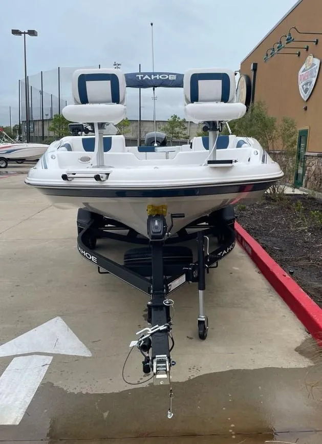 Slide: The Image of 2024 Tahoe 1950 boat on trailer, parked outdoors. - 1