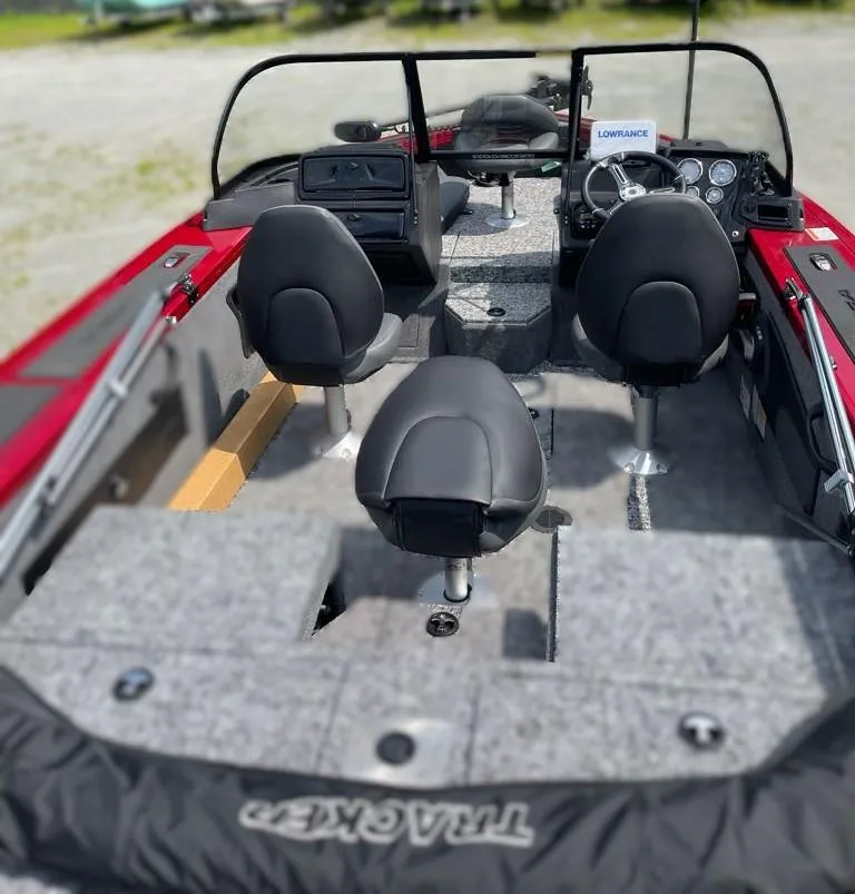 Slide: The Image of 2024 Tracker Targa V-18 Combo boat interior with seating and dashboard. - 2