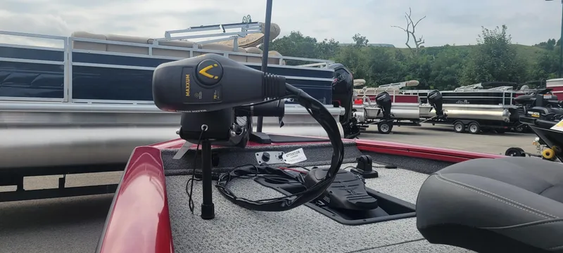 Slide: The Image of 2024 Tracker Pro Team 190 TX boat with Minn Kota Maxxum trolling motor, parked near other boats. - 3