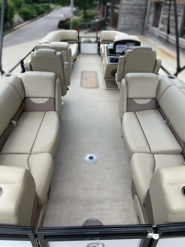 Slide: The Image of 2024 Regency 230 DL3 pontoon boat with spacious seating and modern design. - 2