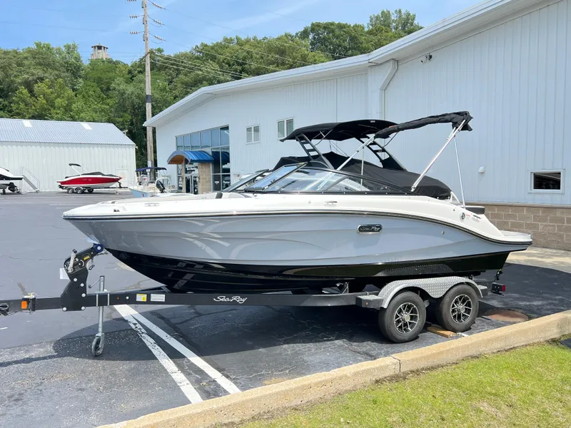 The Image of 2025 Sea Ray SPX 190 boat on a trailer outside a white building. - 0