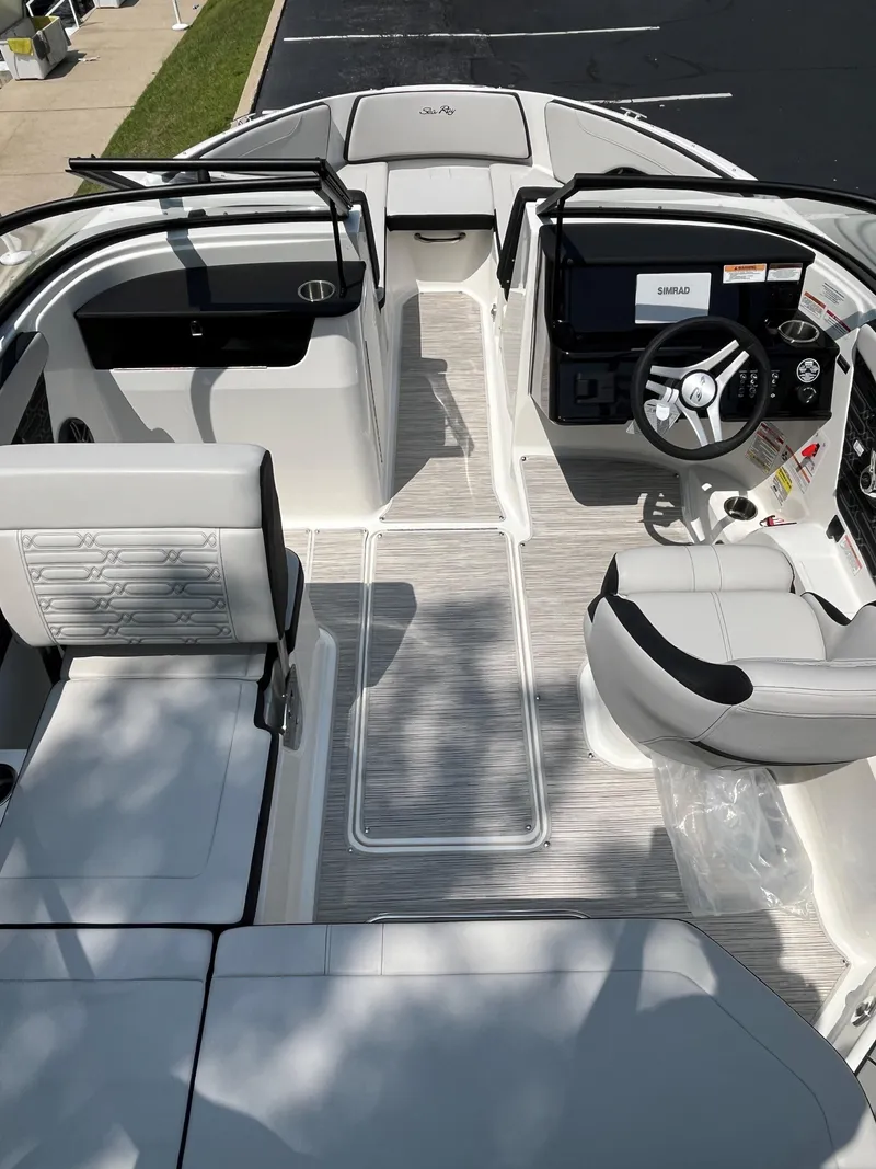 Slide: The Image of 2025 Sea Ray SPX 190 boat interior with modern seating and steering console. - 10