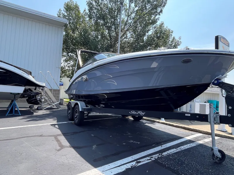 Slide: The Image of 2025 Sea Ray SPX 190 boat on a trailer in a parking lot. - 2