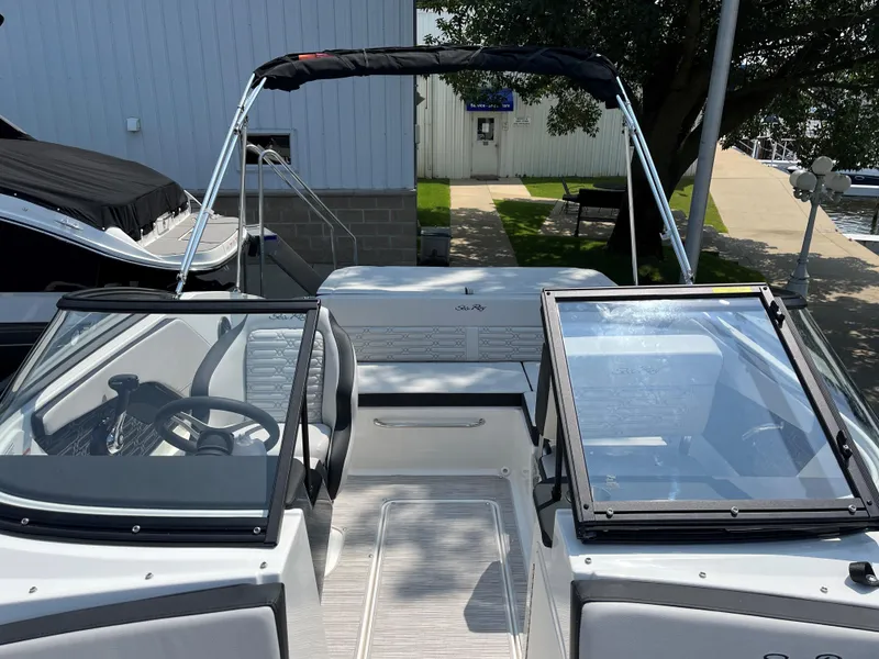 Slide: The Image of 2025 Sea Ray SPX 190 boat interior with open windshield and steering wheel. - 6