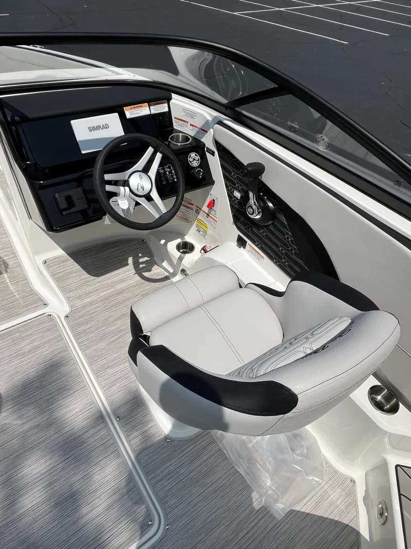 Slide: The Image of 2025 Sea Ray SPX 190 boat interior with steering wheel and captain's chair. - 8