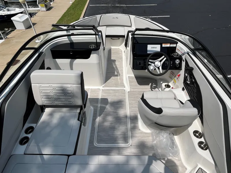 Slide: The Image of 2025 Sea Ray SPX 190 boat interior with modern seating and steering console. - 9