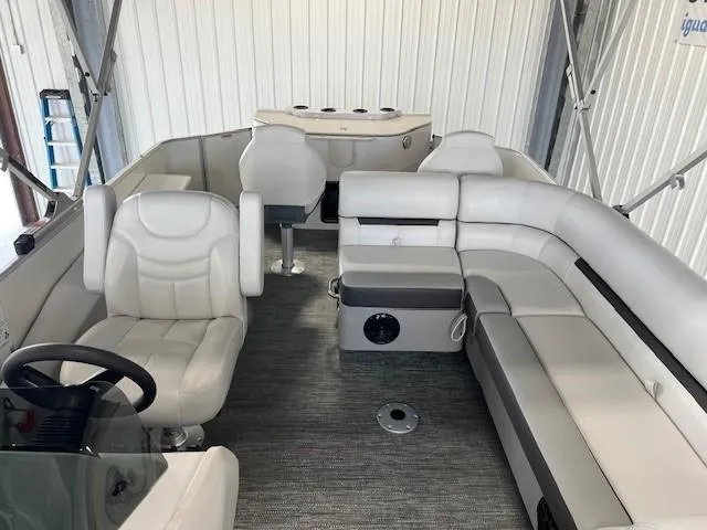 Slide: The Image of 2025 Godfrey Sweetwater 2286 F pontoon boat interior with plush seating and steering console. - 8