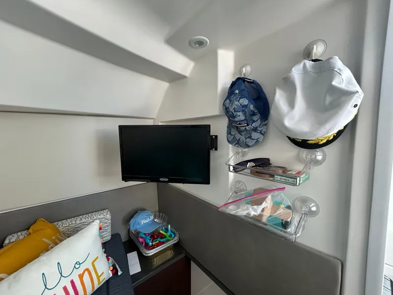 Slide: The Image of Interior of 2019 Everglades 340DC with TV, hats, and pillows. - 15