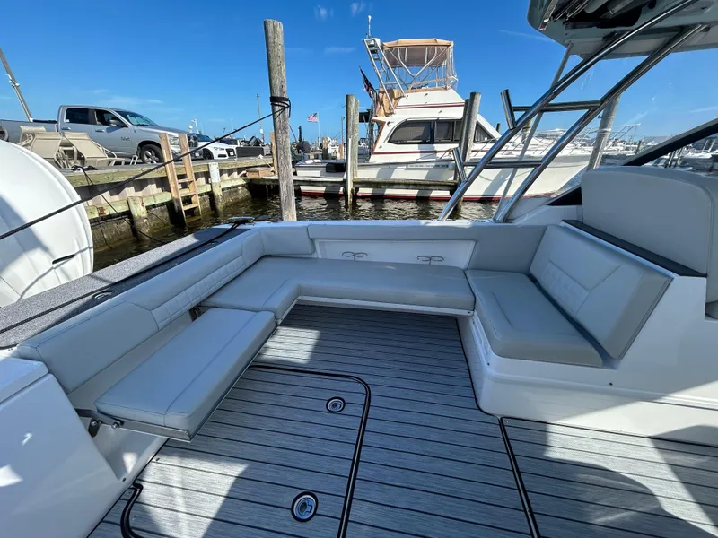Slide: The Image of 2019 Everglades 340DC boat with spacious seating at the dock. - 16
