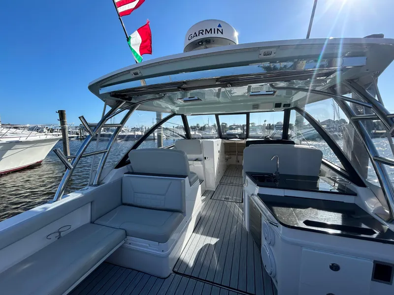 Slide: The Image of 2019 Everglades 340DC boat interior with seating and Garmin navigation system. - 17