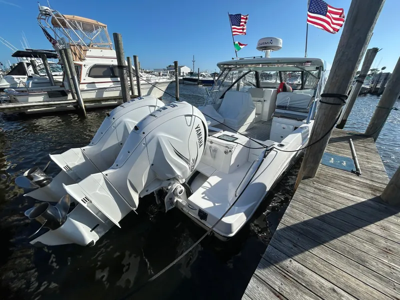 Slide: The Image of 2019 Everglades 340DC boat docked with twin outboard engines. - 2